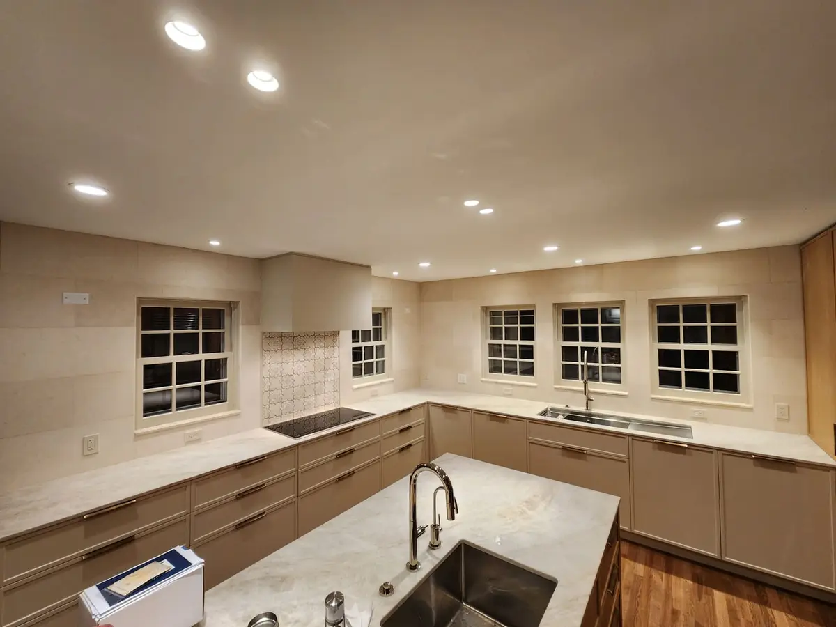 Natural Stone 12x24 — 12x24 natural stone tiles with custom design over cooktop.